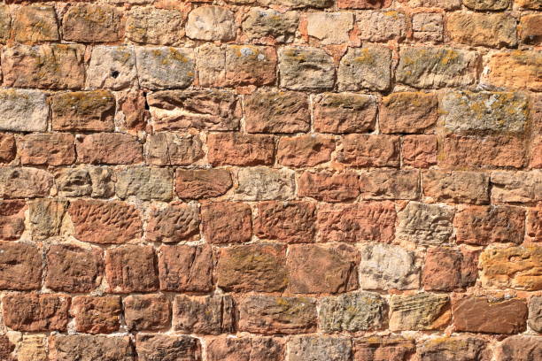 istock Old brick wall, old texture of red stone blocks closeup 1268484367