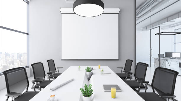 istock Contemporary conference room interior with large blank projection screen 1268484578