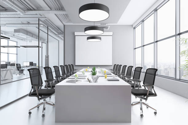 istock Contemporary conference room interior with large blank projection screen 1268484585