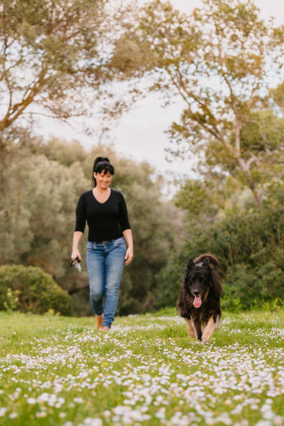Mature woman walking with her dog