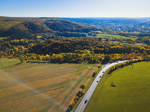 aerial view on car on country road in german autumn landscape