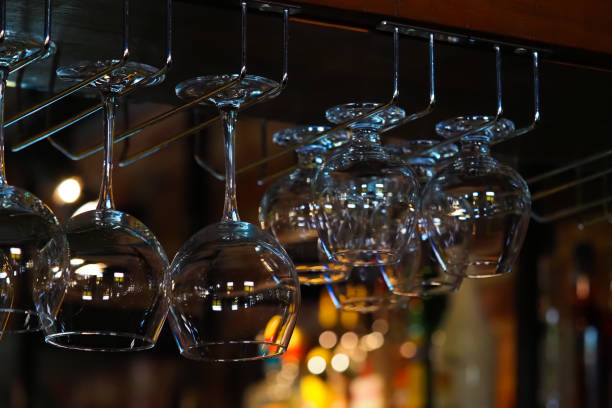 istock Empty glasses for wine above a bar rack. Hanging glasses in a restaurant 1268486636