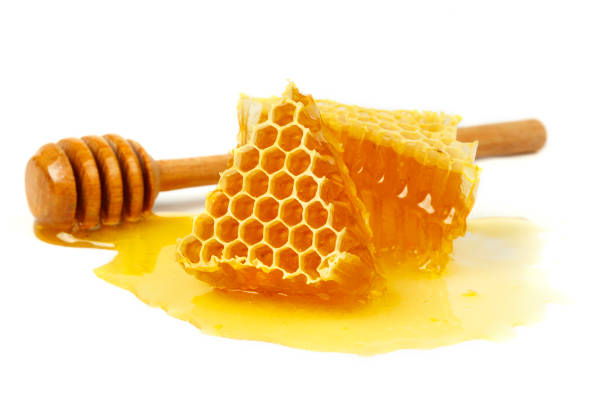 istock Bee combs with honey isolated on a white background. A flowing sweet dessert. A portion of a healthy and healing treat 1268487113