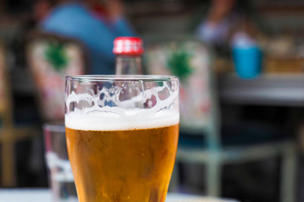 istock Glass with beer in pub, resting people in the background 1268488467