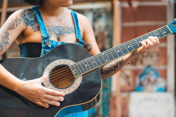 istock Punk woman playing acoustic guitar 1268488609