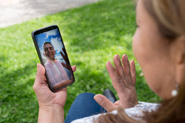 istock Woman outdoors getting a video call on her cell phone 1268490115