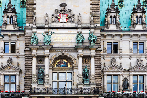 Facade of City Hall, Hamburg, Germany. Freedom won by our elders, may posterity strive to preserve it in dignity. Latin motto of Hamburg on portal facade Hamburger Rathaus