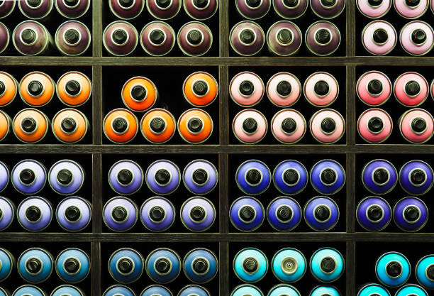 istock Painted spray paint canisters on shelf, multicolored graffiti cans. Paint dispenser, spray bottles, street art 1268490846