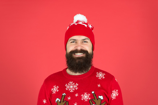 Christmas Sale is on. bearded man in hat red background. mature hipster in knitted sweater. wear warm clothes this season. its cold outside. winter holiday atmosphere. portrait of happy santa man.