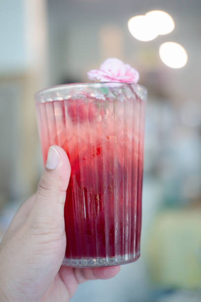 istock Fresh iced tea roselle in glass on hand. Cold summer drink. 1268492749