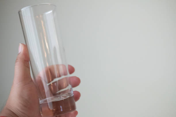 istock Man hand holding empty glass. Close up 1268493269