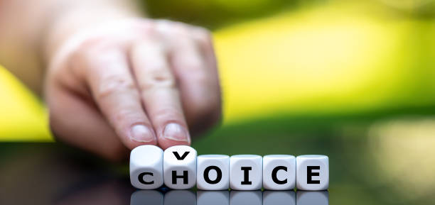 istock Hand turns dice and changes the word choice to voice. 1268495297