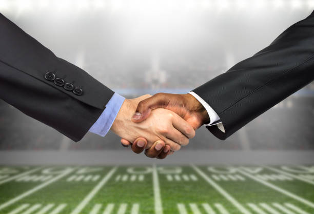 istock men greeting each other with a handshake on a business 1268496736