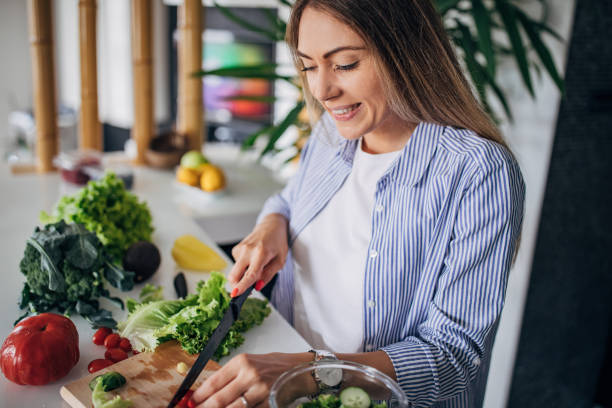 istock Woman in kitchen preparing a vegan salad 1268501949