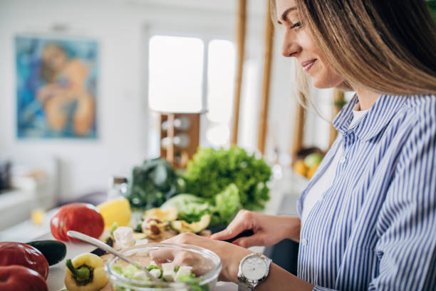 istock Woman in kitchen preparing a vegan salad 1268502004