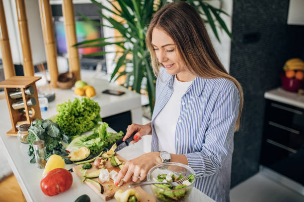 istock Woman in kitchen preparing a vegan salad 1268502066