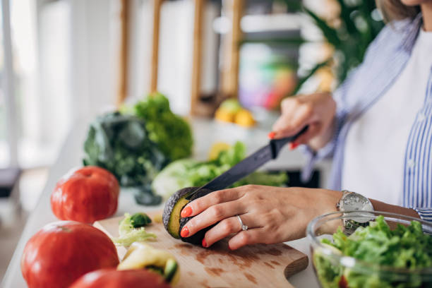 istock Woman in kitchen preparing a vegan salad 1268502308