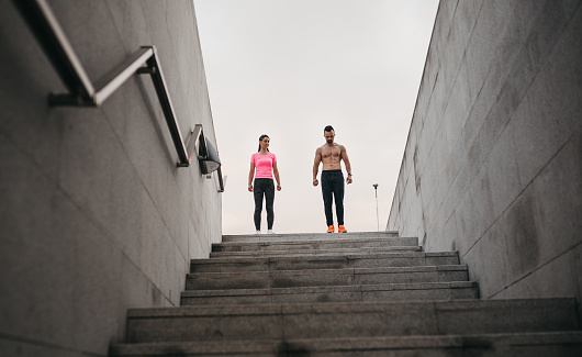 a man and a woman run outside