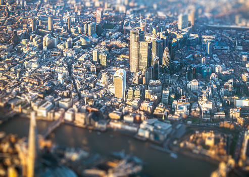 An aerial view of London's traditional financial district, the City of London. Tilt/Shift image, with the Thames defocused at the bottom.