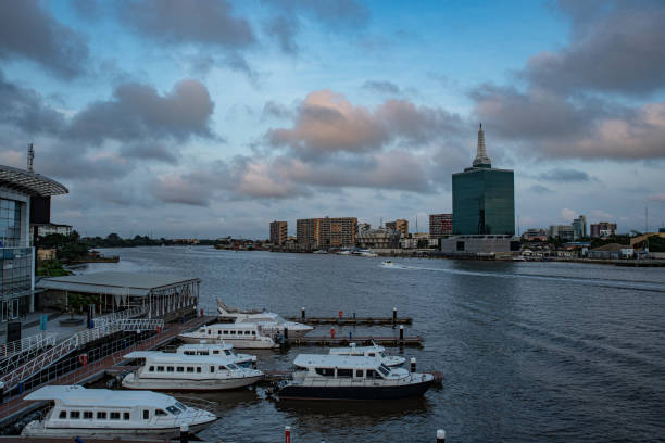 A view of the Lagos lagoon from the top of Falomo bridge Lagos, Nigeria - July 19th 2020: A view of Lagos state waterways transport terminal and the gulf of water separating Victorian Island and Ikoyi lagos nigeria stock pictures, royalty-free photos & images