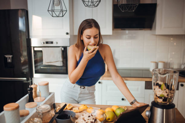 istock Young woman preparing a smoothie 1268508214