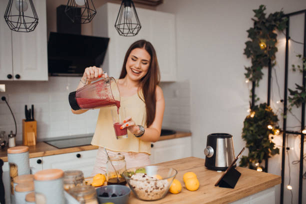 istock Young woman preparing a smoothie 1268508293