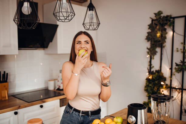 istock Young woman preparing a smoothie 1268508709
