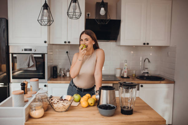 istock Young woman preparing a smoothie 1268508738