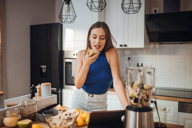 istock Young woman preparing a smoothie 1268508846