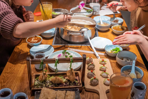 istock Table full of Dishes and Ingredients in Hotpot Restaurant 1268509683
