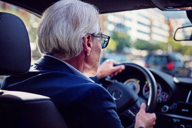 Businessman is driving in a city traffic