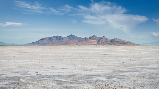 Salt Lake City Salt Flats Desert Panorama under blue sunny summer skyscape close to the city of Bonneville, Salt Lake City, Utah, USA.