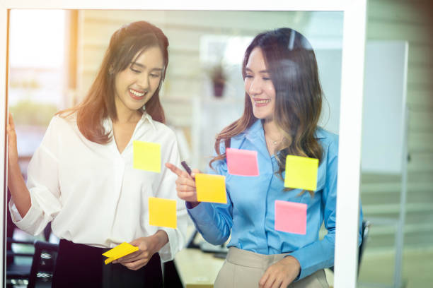 istock Successful women startuppers discussing plan together for work smiling and gesturing, happy women having friendly conversation about business information having meeting in coworking office 1268513556