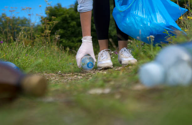 istock Volunteer collecting bottles in the forest. Environment pollution concept. 1268515435