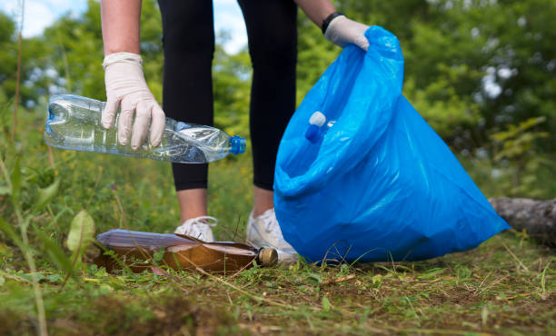istock Volunteer collecting bottles in the forest. Environment pollution concept. 1268515472