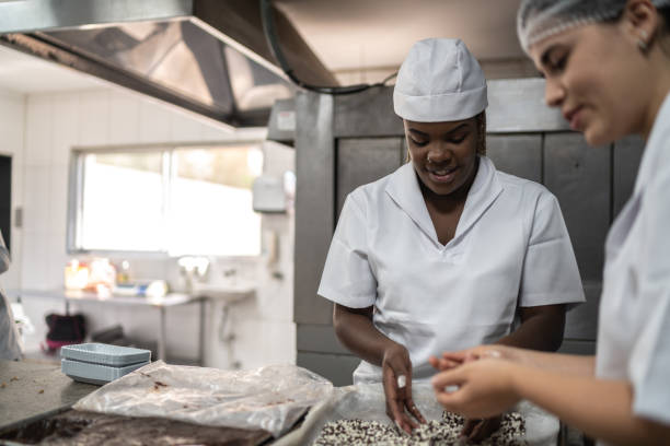 istock Two chefs preparing brigadeiros in a commercial kitchen 1268515747