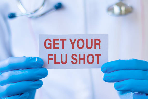 Get Your Flu Shot card in hands of Medical Doctor. Medical and health care concept. Get Your Flu Shot card in hands of Medical Doctor. Medical and health care concept. flu vaccine photos stock pictures, royalty-free photos & images