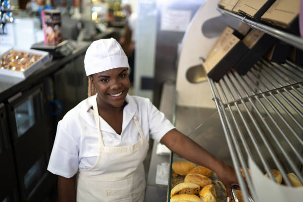 istock Portrait of a female baker picking up bread 1268516595