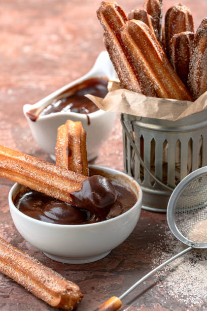 istock Traditional churros sticks with cinnamon and chocolate. 1268517360