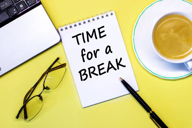 istock Office desk table with computer, pen, coffee cup and glasses. Time for a Break Text written on notebook page. Motivational Concept image 1268518684