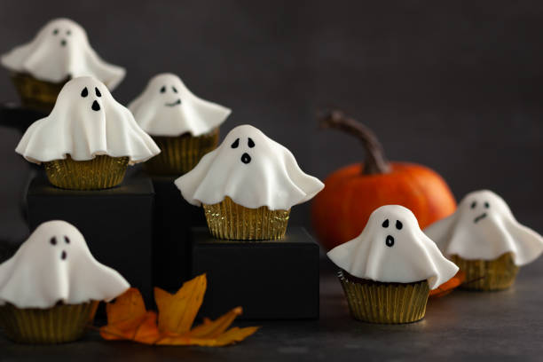 istock Halloween fondant ghost cupcakes on black podiums. 1268532609