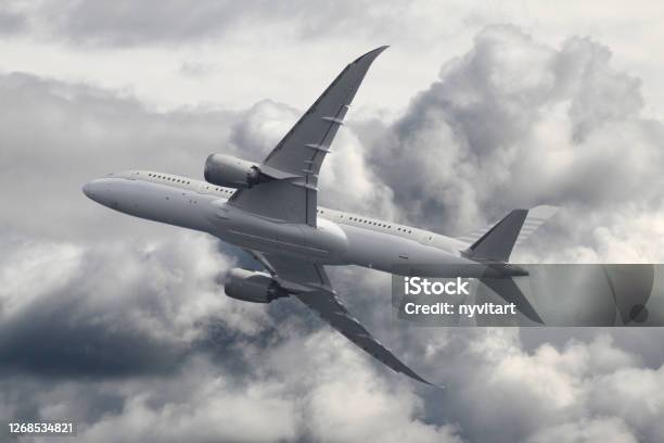 Passenger Airplane Over The Clouds Stock Photo - Download Image Now - Boeing 787, Airplane, Aerospace Industry