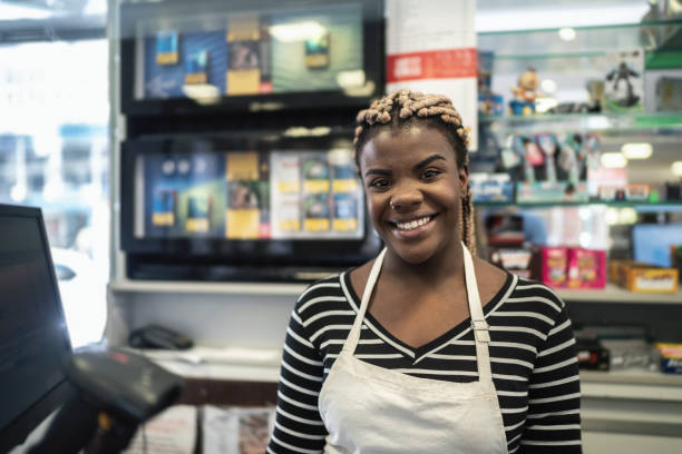 Portrait of a happy cashier working in a restaurant Portrait of a happy cashier working in a restaurant convenience store photos stock pictures, royalty-free photos & images