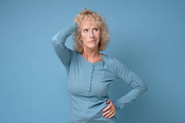 istock Confused caucasian senior woman thinking making a plan. 1268538495