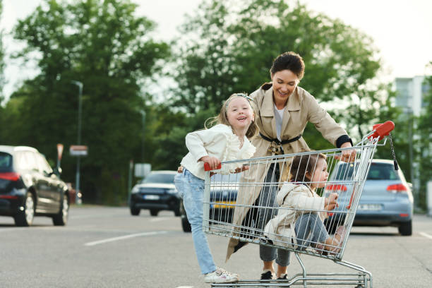 istock Happy mother and her daughters are having fun with a shopping ca 1268538724