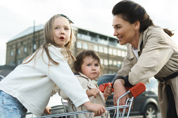 istock Happy mother and her daughters are having fun with a shopping ca 1268538759