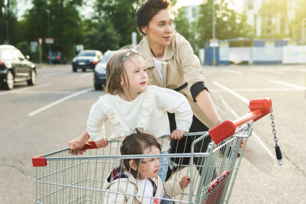 istock Happy mother and her daughters are having fun with a shopping ca 1268539034