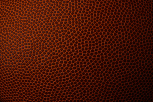 макро изображение футбольной текстуры - американский футбол мяч стоковые фото и изображения
