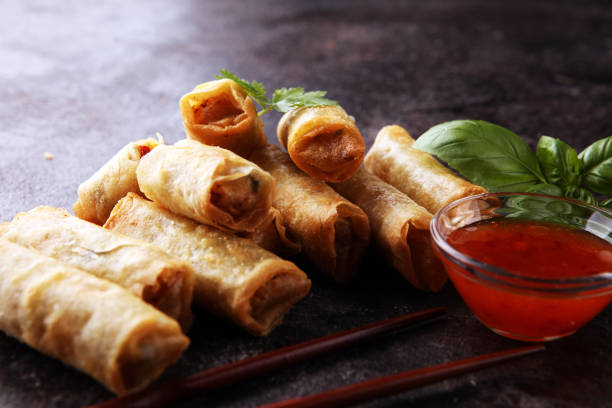 istock Fried chinese spring rolls with sweet chili sauce on rustic background 1268540661
