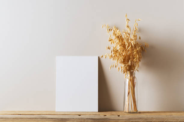 istock Mock up with whte empty wall and dried flowers, oat on wooden table 1268540678